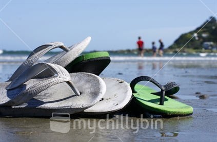 Three Brothers play in the surf at Lyall Bay in Wellington, while their jandals wait for them safely up the beach.