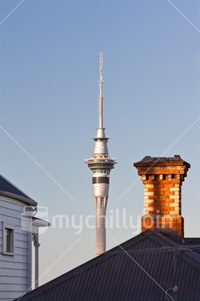 Auckland Sky Tower alongside an old brick chimney.