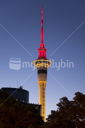Sky Tower lit up in red and yellow during the Lantern Festival