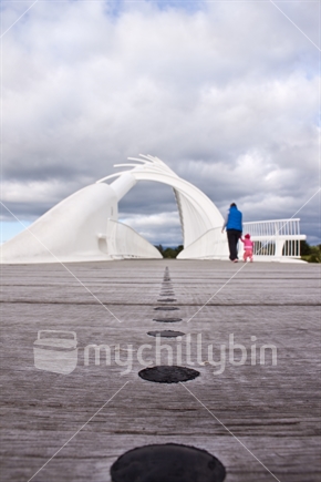 A mother and daughter walking across New Plymouth's Te Wera Wera bridge.