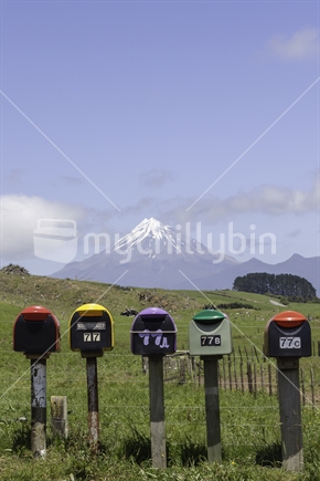 Row of postboxes with Mount Taranaki in the background.