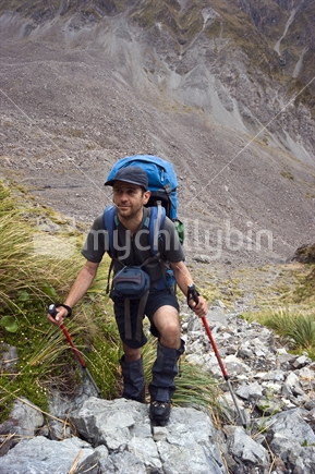 Male tramper climbs to Tarn Col, Arthurs Pass National Park (raised ISO)