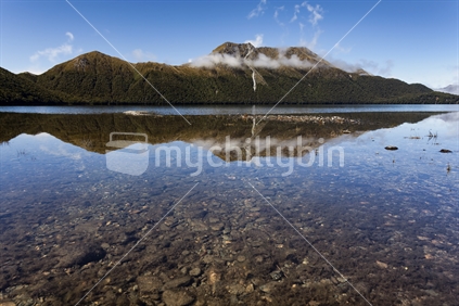 Remote mountains preside over tranquil Green Lake, Fiordland National Park, Southland