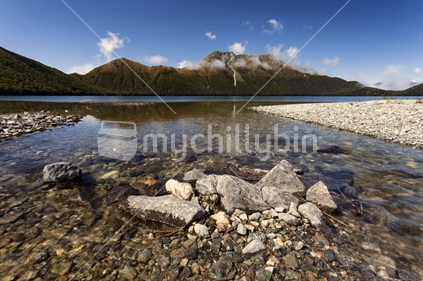 Stream flows into tranquil Green Lake, Fiordland National Park, Southland