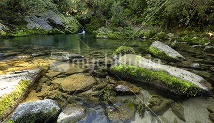 Beautiful green pool and mossy rocks in Riwaka River, Tasman, Nelson
