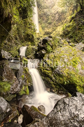 Whisky Falls dropping off mountain wall into Lake Rototiti. Nelson Lakes National Park.