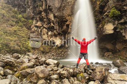 Red man enjoys the wild ambience of Taranaki Falls on the flanks of Mount Ruapehu, Tongariro National Park