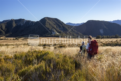 Two trampers explore Thousand Acres Plateau in southern Kahurangi National Park