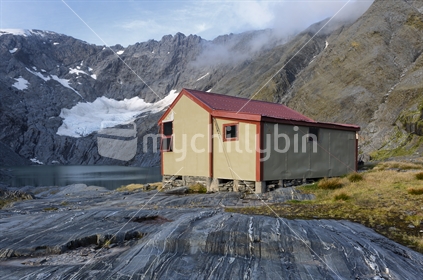 Ivory Lake Hut with the shrinking glacier beyond, sure evidence of climate change.