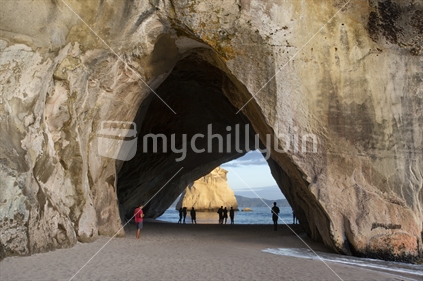 Crowds gather inside the iconic sea cave at Cathedral Cove on the Coromandel Peninsula