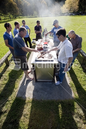 Kiwi blokes around smoking barbeque