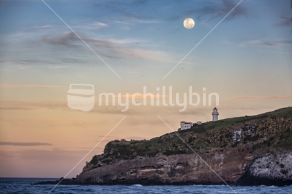 Tairoa Head lighthouse on Otago Peninsula with full moon rising