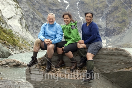 Three friends at Lucidus Lake in the remote Wilkin River of Mt Aspiring National Park, Otago