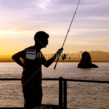 Fisherman silhouette with Fifeshire Rock, Nelson