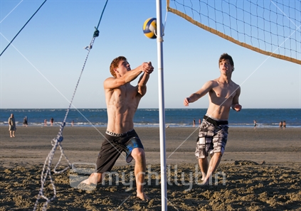 Teenager brothers play volleyball on Tahunanui Beach, Nelson