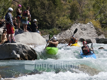 Trio of bright young kayakers are watched as they drop down the Matakitaki River, Buller District