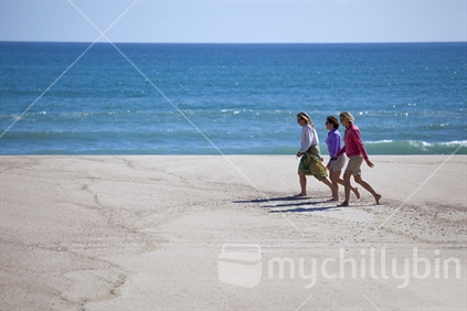 3 female friends enjoy walking Heaphy Beach, Kahurangi National Park