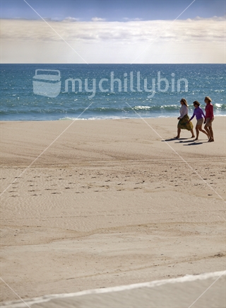 Three ladies barefoot on Heaphy Beach, Kahurangi National Park