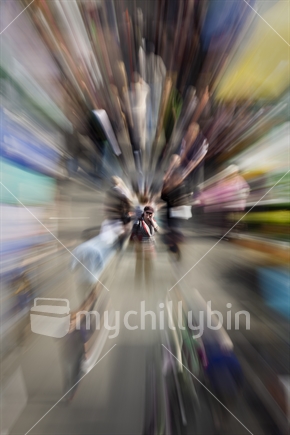 Zoom burst - Female shopper stops to answer cell phone in busy shopping market