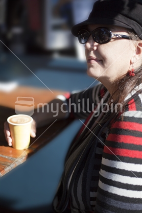 Female drinks takeaway coffee at market stall