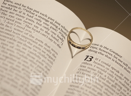 Wedding ring on Love Chapter of the Bible creates a love heart