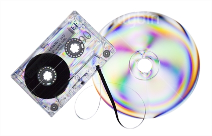 Rainbow colours on cassette tape and transparent plastic compact disc