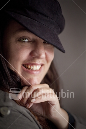Cute brunette-haired lady with black cap smiles (800 ISO)