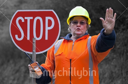 Lady traffic controller on rural road with big STOP sign and hand signal