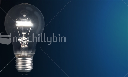 Illuminated light bulb isolated on blue background