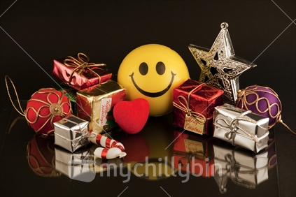 Happy Xmas - yellow smiley face surrounded by miniature gifts