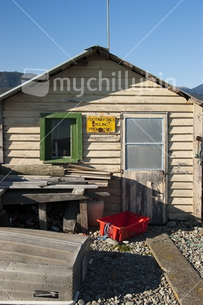 Rustic, weatherboard boat shed. Boulder Bank, Nelson