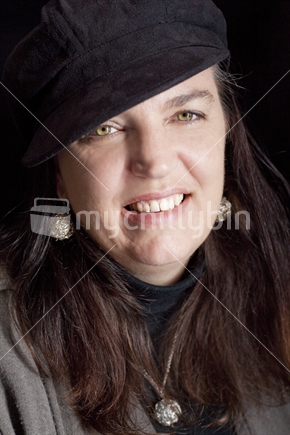 Brunette-haired woman, in black cap