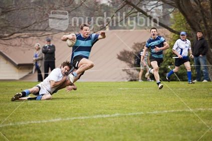 Nelson College rugby player breaks through tackle en route to try line