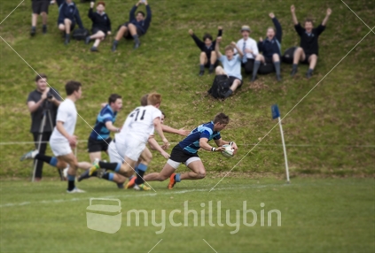 Teenage boy scores a try in a tournament at Nelson College, the birthplace of New Zealand rugby. Blurred lens effect
