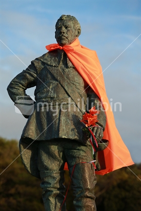 Statue of Abel Tasman in orange cloak stands sentinel at Nelson's Tahuna beach