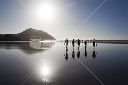 Five friends wander on Golden Bay's remote Wharariki Beach