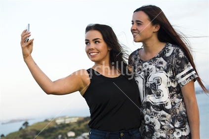 Two 18-year-old teenage girls pose for a selfie
