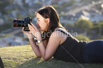 Young woman photographer with camera close