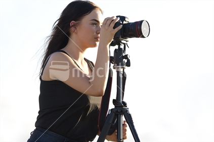 18-year-old girl and DSLR camera on tripod - angled view