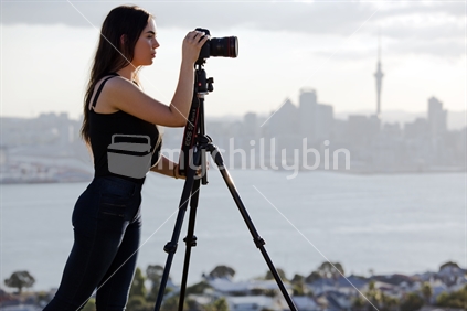 18-year-old girl and DSLR camera on tripod - profile view