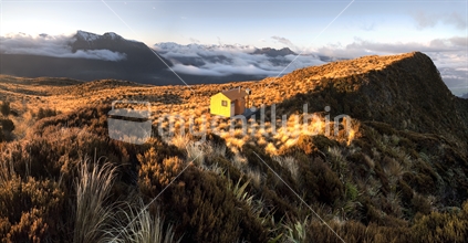 Mt Brown Hut is dwarfed in the golden tussocks of the Southern Alps.
