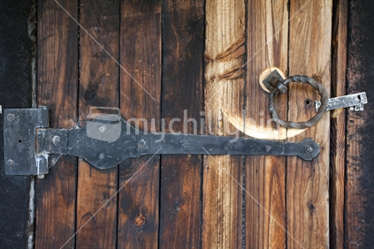 Wooden slat door with iron hinges