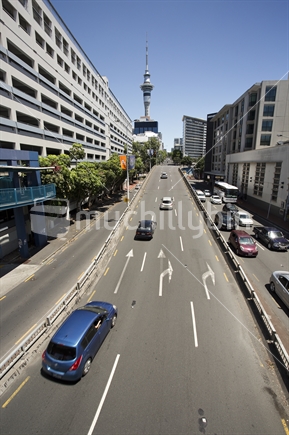 Busy traffic on  Hobson Street with Auckland's iconic Sky Tower beyond