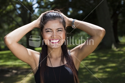 Happy Philippino woman with hands on her head in an Auckland Park