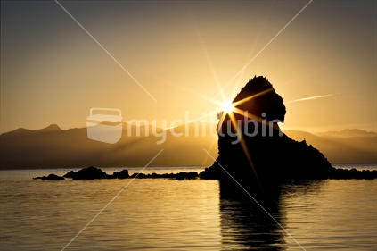 Setting sun kisses Fifeshire Rock in Tasman Bay, Nelson