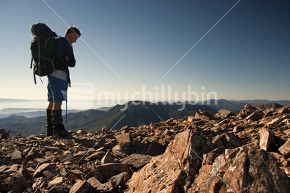 Male tramper on summit of Mount Rintoul, a high point of Te Araroa Trail, Nelson