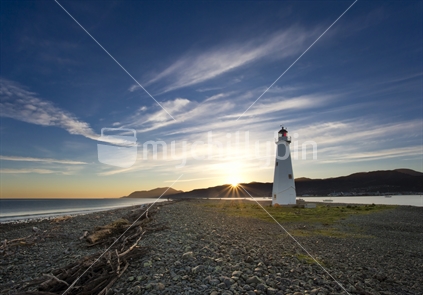 Historic lighthouse stands sentinel on Nelson's Boulder Bank at dawn