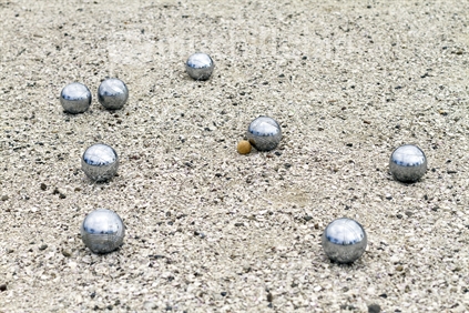 Group of petanque or boules on shell court. (focus jack)