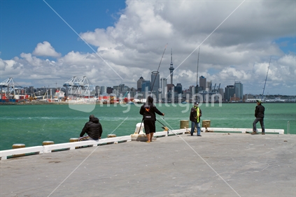 Fishers on wharf with Auckland city in the background