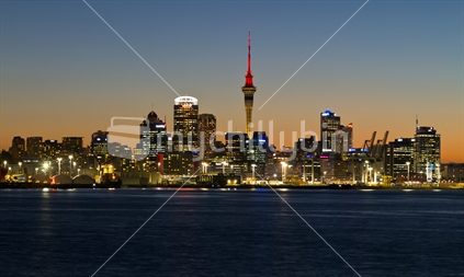 Auckland City CBD at dusk with sunset glow behind buildings